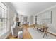 Bright home office with hardwood floors, natural light, and a cozy sitting area at 405 Tharps Ln, Raleigh, NC 27614