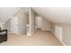 A spacious and bright attic area is carpeted, providing additional storage and living space at 415 King George Loop, Cary, NC 27511
