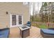 Back deck with comfortable seating, a stylish fire pit table, and access to the backyard at 415 King George Loop, Cary, NC 27511