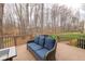 Open backyard deck featuring comfortable cushioned seating with a view of the expansive yard at 415 King George Loop, Cary, NC 27511