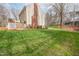 Lush green backyard with mature trees, well-manicured lawn, and a deck providing ample space at 415 King George Loop, Cary, NC 27511