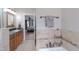 Bright bathroom with granite counters, neutral tile backsplash and flooring, and access to the primary bedroom at 415 King George Loop, Cary, NC 27511