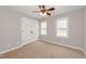 Bedroom featuring carpet floors, a ceiling fan, and natural light from two windows at 415 King George Loop, Cary, NC 27511