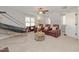 Spacious bonus room with hardwood flooring, ceiling fan, recessed lighting, and three leather recliners at 415 King George Loop, Cary, NC 27511