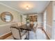 Inviting dining room boasts modern light fixture, elegant rug and a stylish wood table with seating at 415 King George Loop, Cary, NC 27511