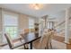 Dining room with elegant table, chairs, and lighting, plus views to the entry and stairs at 415 King George Loop, Cary, NC 27511