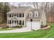 Traditional two-story home with a two car garage and lush front lawn and mature landscaping at 415 King George Loop, Cary, NC 27511