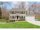 Charming two-story home with a well-maintained lawn and a basketball hoop in the driveway at 415 King George Loop, Cary, NC 27511