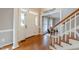 Inviting foyer with hardwood floors, white trim, and a view into a cozy living space at 415 King George Loop, Cary, NC 27511