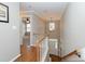 A staircase leads to the front door, with a window that lets natural light into the hallway at 415 King George Loop, Cary, NC 27511