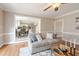 Comfortable living room featuring hardwood floors, crown molding, and open access to the kitchen at 415 King George Loop, Cary, NC 27511