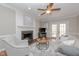Bright living room featuring a fireplace, hardwood floors, and access to the outdoor patio at 415 King George Loop, Cary, NC 27511