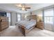 Spacious main bedroom featuring carpet floors, a ceiling fan, and natural light from two windows at 415 King George Loop, Cary, NC 27511