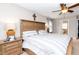 Comfortable bedroom showcasing a wooden bed frame with a nightstand and serene natural lighting at 415 King George Loop, Cary, NC 27511