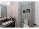 Updated powder room with granite countertop, modern fixtures, and neutral paint at 415 King George Loop, Cary, NC 27511