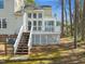 Backyard view of deck with stairs and latticework, plus house exterior and trees at 42 Renwick Ct, Raleigh, NC 27615