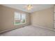 Bright bedroom featuring neutral walls, plush carpet, and a bright window offering natural light at 42 Renwick Ct, Raleigh, NC 27615