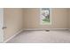 Comfortable bedroom featuring neutral walls, plush carpet, and a bright window for natural light at 42 Renwick Ct, Raleigh, NC 27615