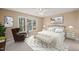 Cozy bedroom with natural light from large windows, a ceiling fan, and neutral tones at 42 Renwick Ct, Raleigh, NC 27615