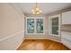 Cozy dining area with wood flooring, a chandelier, and bright windows at 42 Renwick Ct, Raleigh, NC 27615