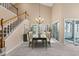 Elegant dining room with a chandelier, tall ceilings, and sliding glass doors at 42 Renwick Ct, Raleigh, NC 27615