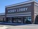 Exterior view of Hobby Lobby featuring a brown facade, white trim, and a clear storefront at 42 Renwick Ct, Raleigh, NC 27615