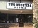 Two Roosters Ice Cream storefront with stone facade, large windows, and visible signage at 42 Renwick Ct, Raleigh, NC 27615