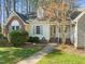 Charming home with a combination of brick and siding accents, a well-manicured lawn, and a welcoming walkway at 42 Renwick Ct, Raleigh, NC 27615