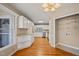 Spacious kitchen with stainless steel appliances, white cabinets, and wood flooring at 42 Renwick Ct, Raleigh, NC 27615