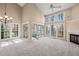 Bright living room featuring a fireplace, large windows, and a ceiling fan for optimal comfort at 42 Renwick Ct, Raleigh, NC 27615