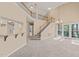 Spacious living room featuring a staircase, chandelier, and a view of the outside at 42 Renwick Ct, Raleigh, NC 27615