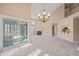 Open-concept living room featuring a fireplace, chandelier, and sliding glass doors at 42 Renwick Ct, Raleigh, NC 27615
