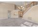 Open-concept living room featuring a staircase, chandelier, and plush carpeting at 42 Renwick Ct, Raleigh, NC 27615