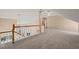 Carpeted loft area with railing overlooking living space at 42 Renwick Ct, Raleigh, NC 27615