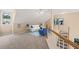 Bright loft area with a cozy seating arrangement and views of the stairs at 42 Renwick Ct, Raleigh, NC 27615