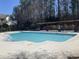 Community pool with clear water, surrounded by concrete decking and shaded lounge area perfect for relaxing and recreation at 421 Glencrest Pl, Chapel Hill, NC 27514