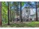 Home's backyard, surrounded by trees, has a two-tiered deck with stairs leading to the lower level at 4622 Vendue Range Dr, Raleigh, NC 27604