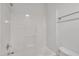 Bright white tub and shower combination with chrome fixtures and a neutral tile at 4622 Vendue Range Dr, Raleigh, NC 27604