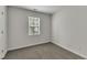 Neutral bedroom featuring carpet, window, and light-colored walls, awaiting your personal touch at 4622 Vendue Range Dr, Raleigh, NC 27604