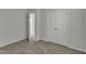 Bedroom with double closets and neutral carpeting, leading to an open bathroom at 4622 Vendue Range Dr, Raleigh, NC 27604
