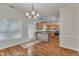 Bright dining room featuring hardwood floors, elegant lighting, and a view into the kitchen at 4622 Vendue Range Dr, Raleigh, NC 27604