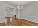 Bright dining room featuring hardwood floors, view into the living room with fireplace at 4622 Vendue Range Dr, Raleigh, NC 27604