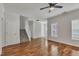 Bright living room features hardwood floors, a staircase, and two windows creating a cozy and inviting atmosphere at 4622 Vendue Range Dr, Raleigh, NC 27604