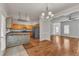 Open floor plan showcasing hardwood floors, modern lighting, and seamless transitions between the dining area and kitchen at 4622 Vendue Range Dr, Raleigh, NC 27604