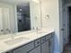Bathroom boasts a double sink vanity with contemporary fixtures and stylish mirrors at 511 Valentine Ct, Graham, NC 27253