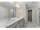 Bright bathroom featuring double sinks, modern fixtures, and neutral tones offering a clean and contemporary design at 511 Valentine Ct, Graham, NC 27253