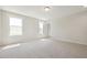 Bright bedroom with neutral carpet, large windows, and a doorway at 511 Valentine Ct, Graham, NC 27253