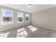 Bright bedroom with three large windows and plush neutral carpeting at 511 Valentine Ct, Graham, NC 27253