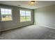 Neutral bedroom featuring plush carpeting and double windows, offering ample natural light and a serene atmosphere at 511 Valentine Ct, Graham, NC 27253