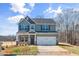 Charming two-story home with a gray exterior, a two-car garage, and a well-manicured lawn at 511 Valentine Ct, Graham, NC 27253